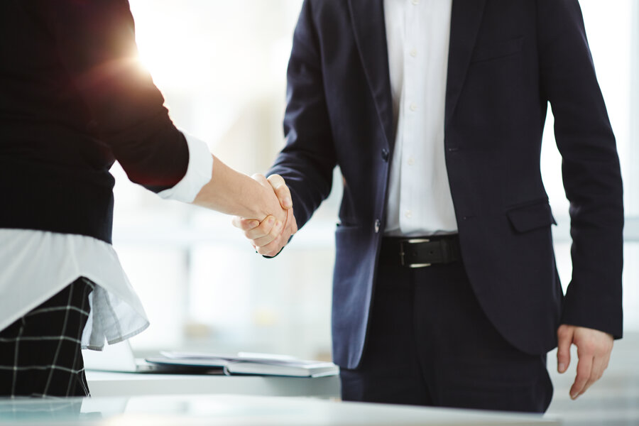 Handshake of successful business partners after negotiation and signing new contract