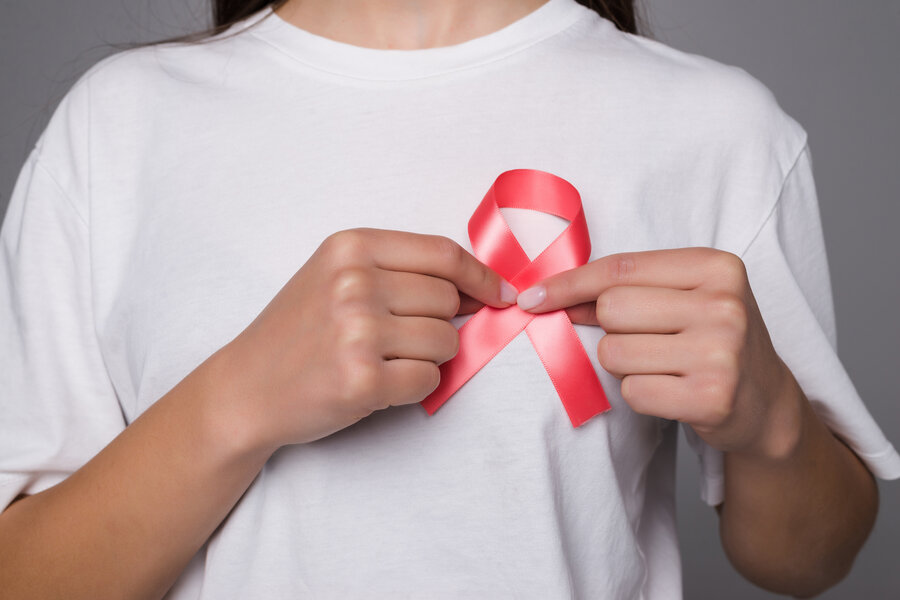 World Breast Cancer Day Concept,health care - woman wore white t-shirt with Pink ribbon for awareness, symbolic bow color raising on people living with women's breast tumor illness