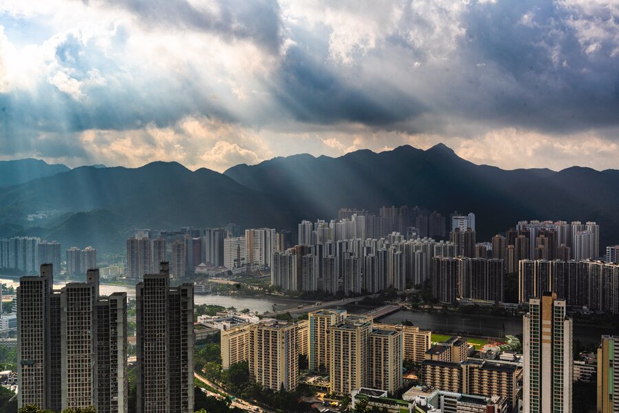 A beautiful aerial shot of apartment buildings area in an urban city with amazing clouds and sunlight