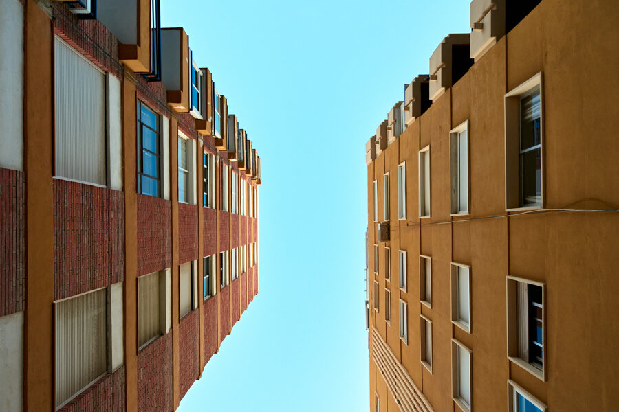 A low angle shot of apartment buildings against clear sky background