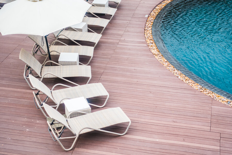 Umbrella and chair around beautiful luxury outdoor swimming pool in hotel resort